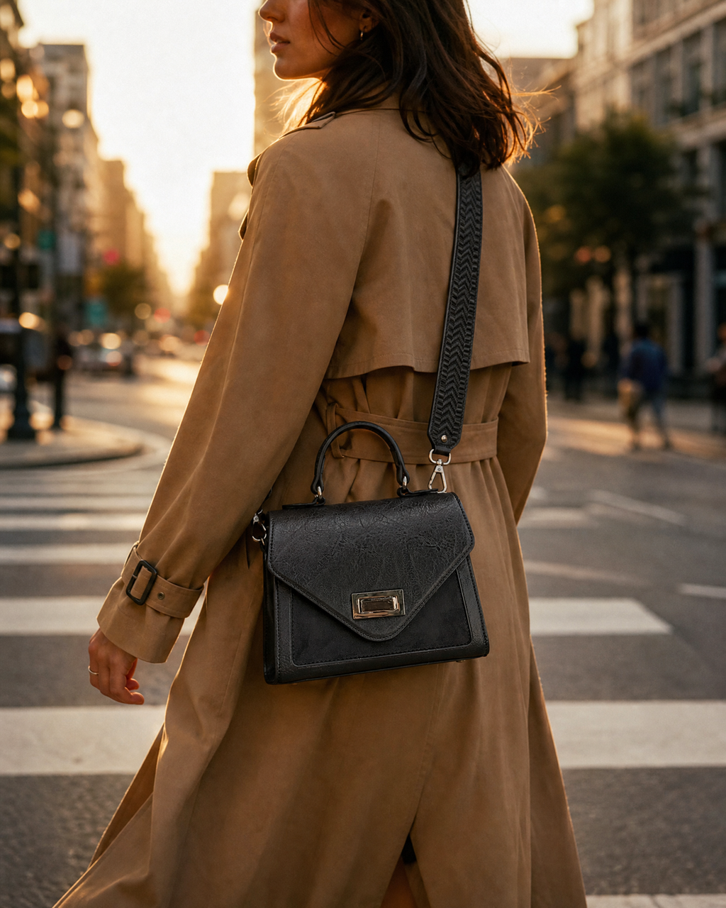 D.Y. Valle Aurora Mini Satchel Bag in slate grey worn crossbody over a camel trench coat on a golden-hour city street.
